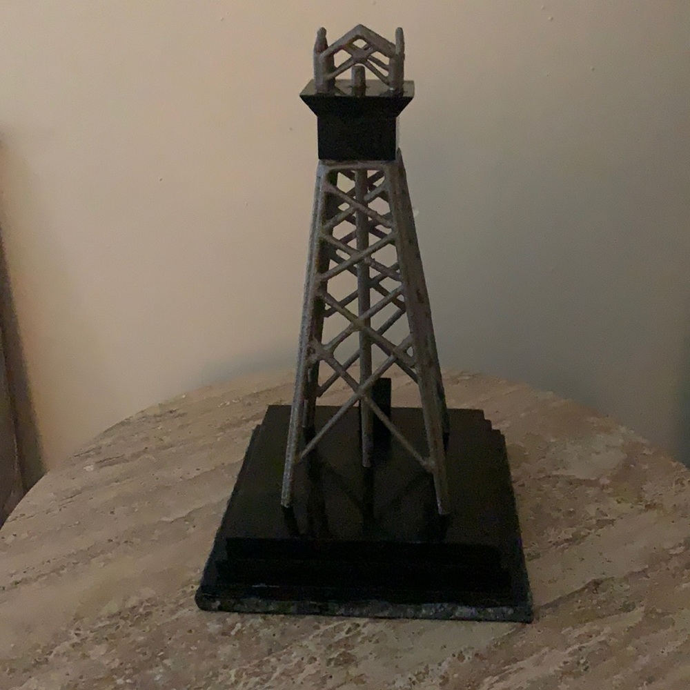 Antique metal oil derrick with marble base